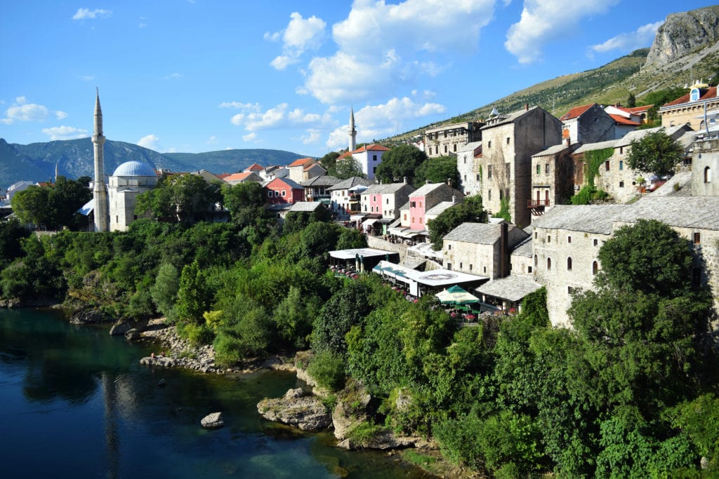 Photo of Mostar old town from the old bridge, added to a post about the best short travel quotes and travel captions