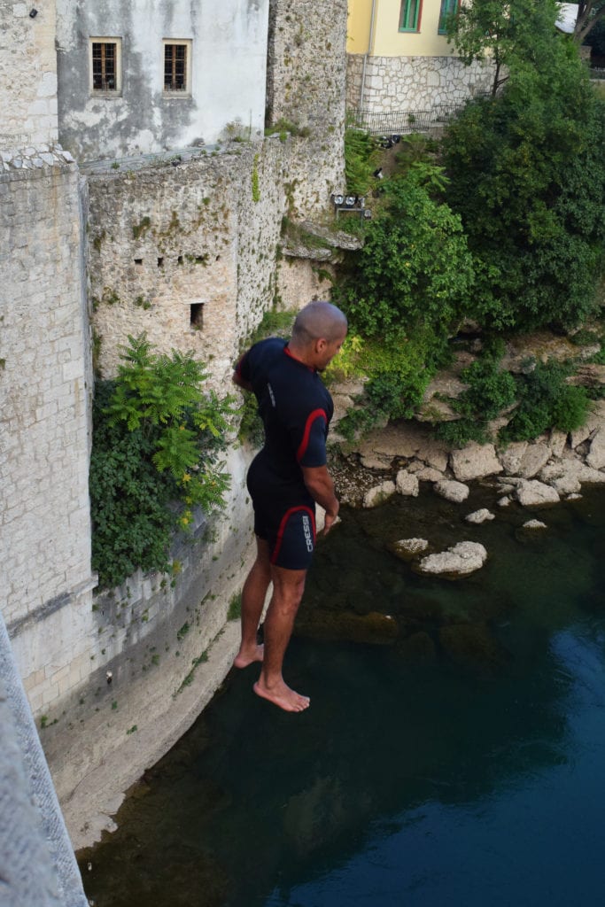 man jumping from stari most bridge mostar into nerevta river, watching is one of the best things to do mostar bosnia