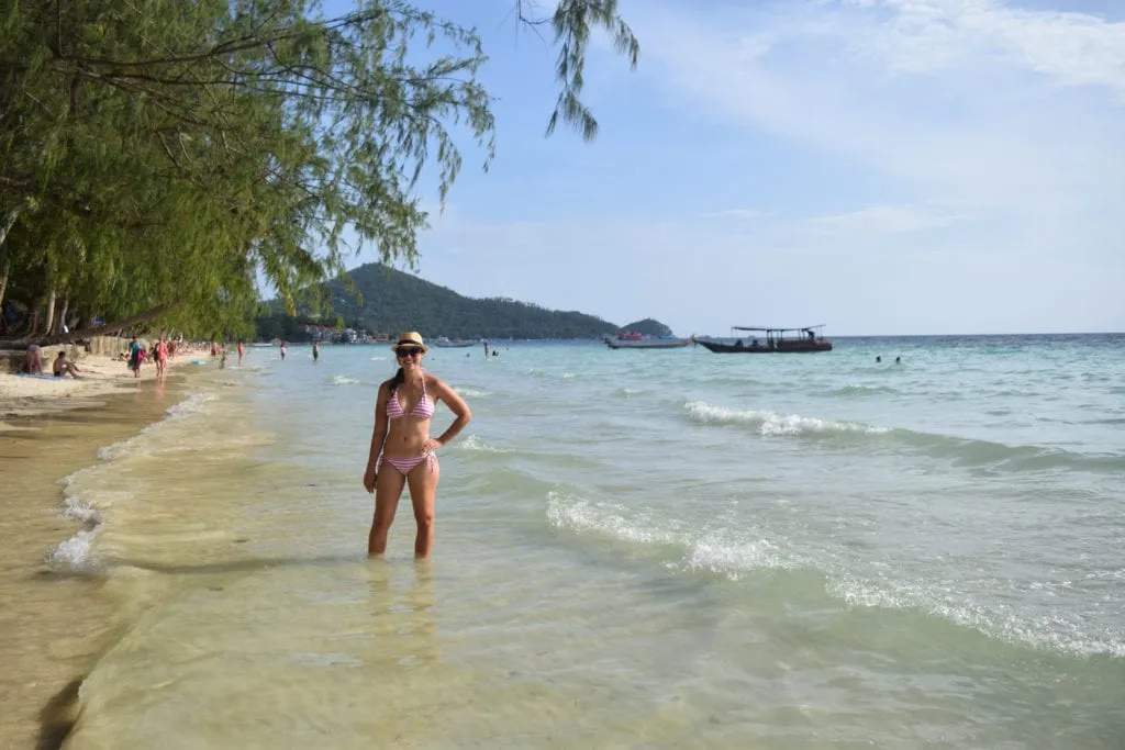 kate storm in a pink and white bikini standing on sairee beach in koh tao thailand, a fun addition to our thailand travel budget