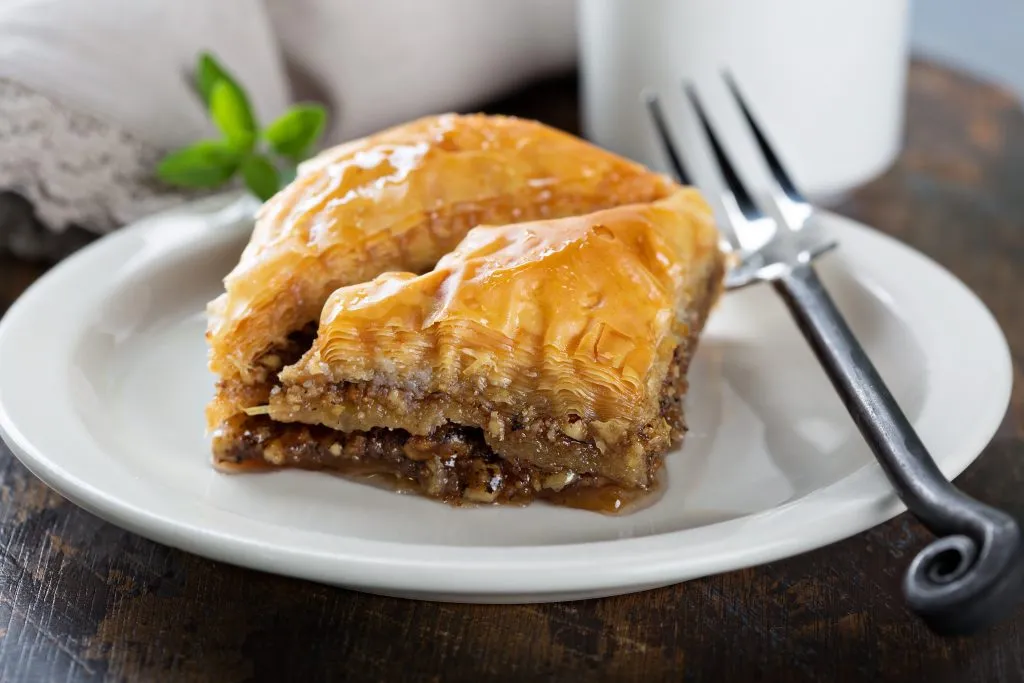 white plate with 2 triangles of baklava