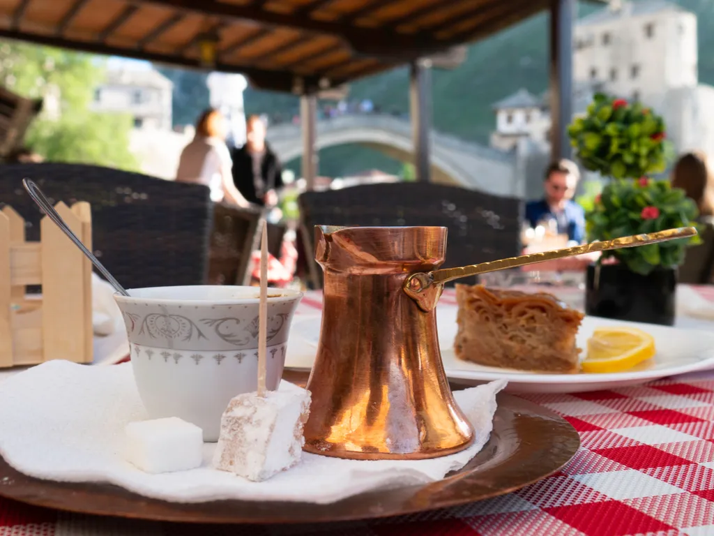traditional bsonian coffee at a cafe, table has a red and white checkered tablecloth