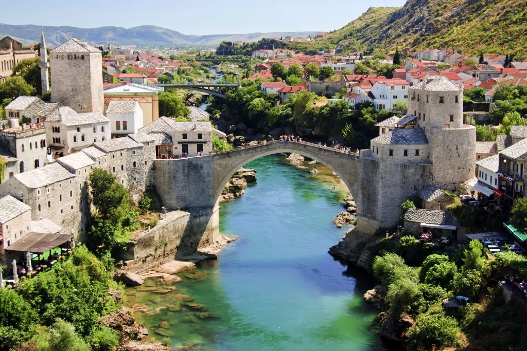 stari most bridge as seen from across the river, one of the best things to do in mostar bosnia and herzegovina