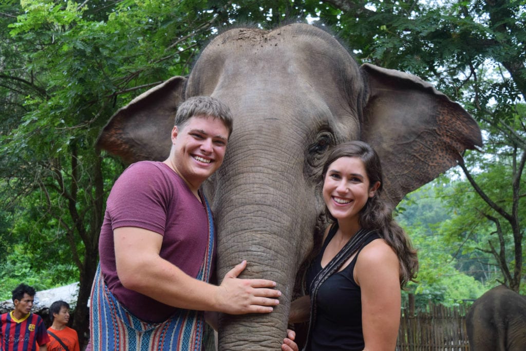 kate storm and jeremy storm posing with an elephant during long term travel in southeast asia