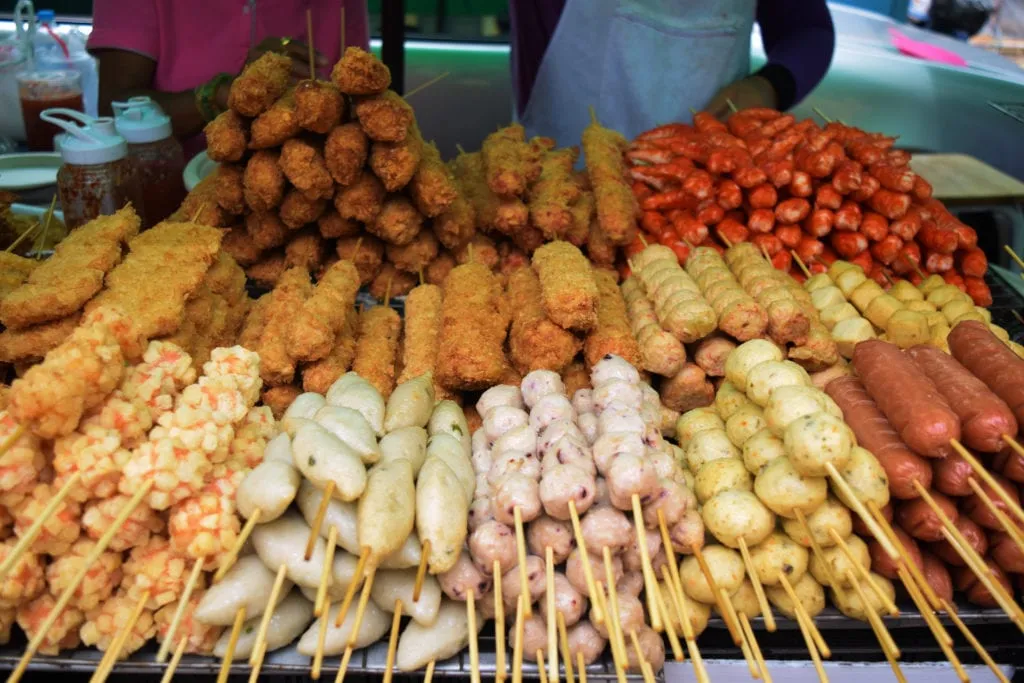 collection of fried food on a stick, some of the street food of bangkok