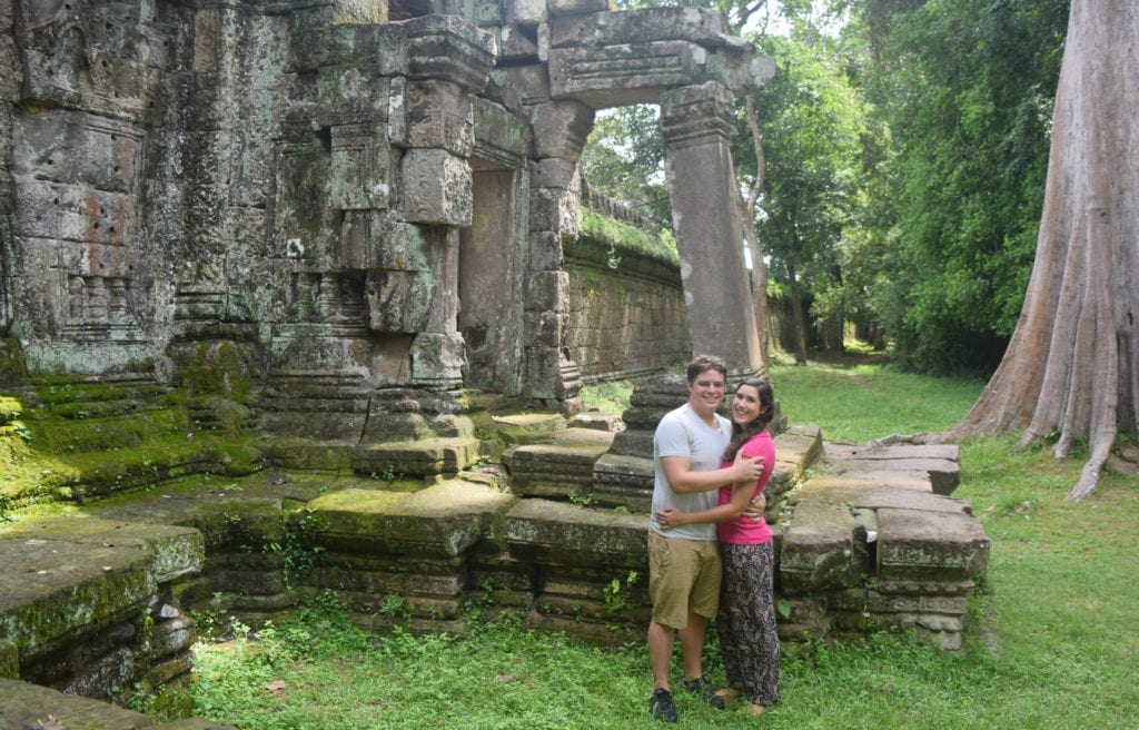 kate storm and jeremy storm standing in front of a ruin in angkor wat cambodia