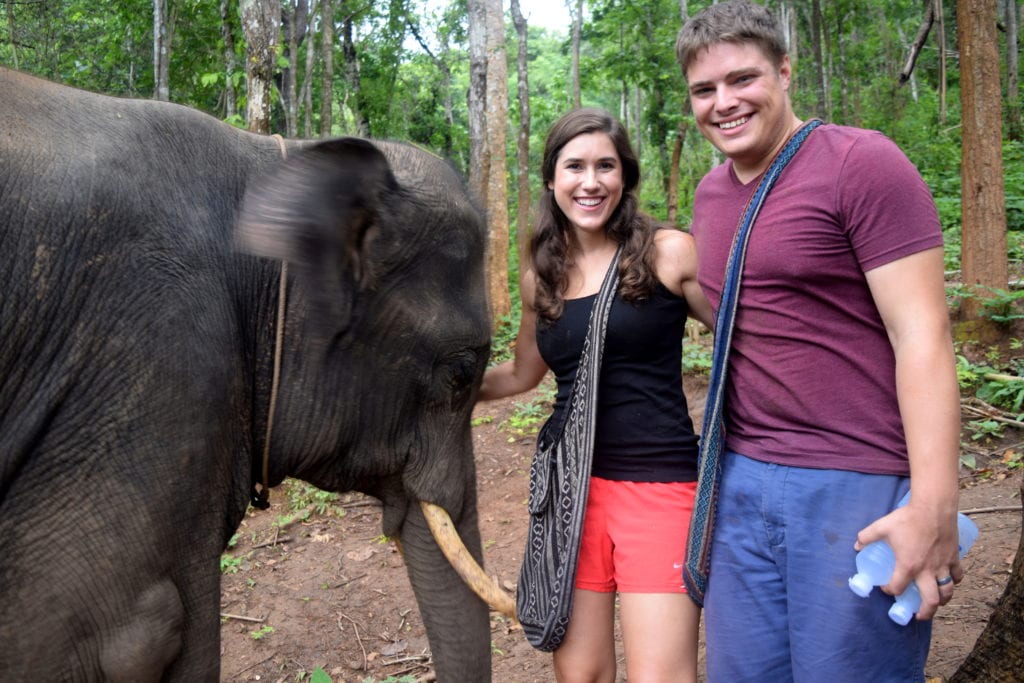 kate storm and jeremy storm with an elephant near chiang mai, a splurge on a thailand travel budget