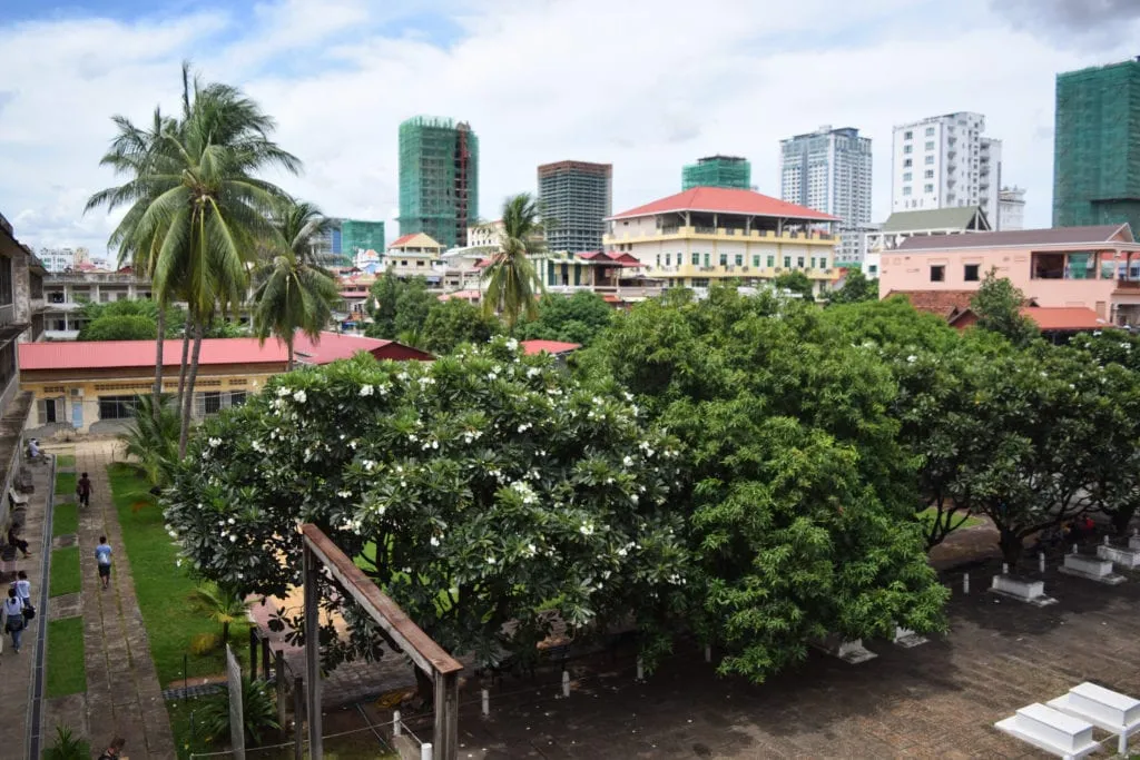 view of the courtyard with flowering trees at tuol sleng phnom penh cambodia