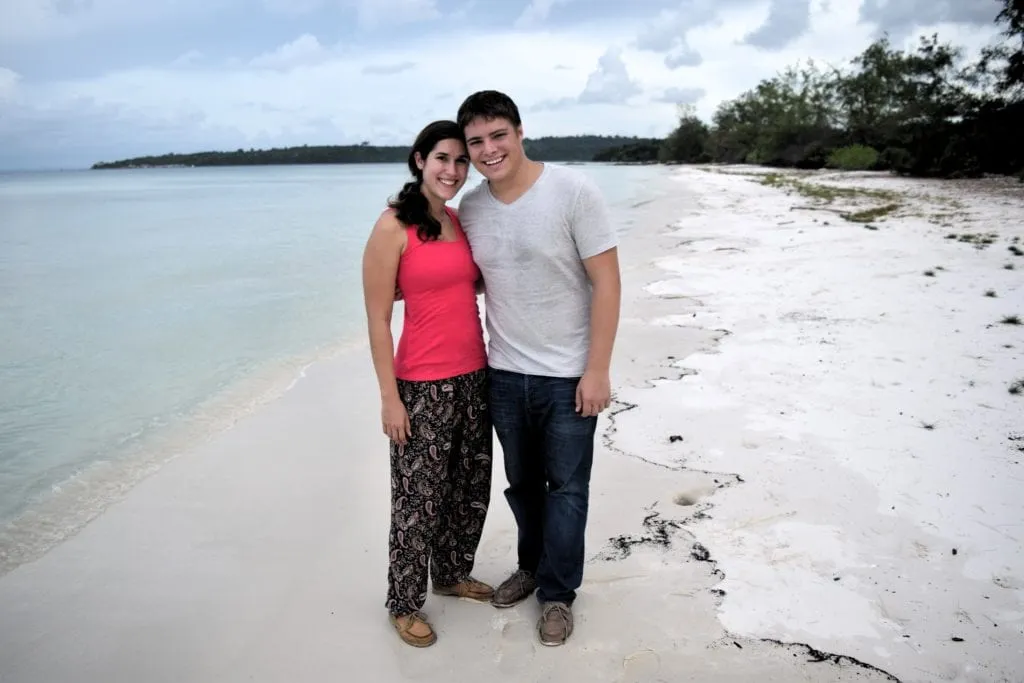 kate storm and jeremy storm standing on a beach in koh rong