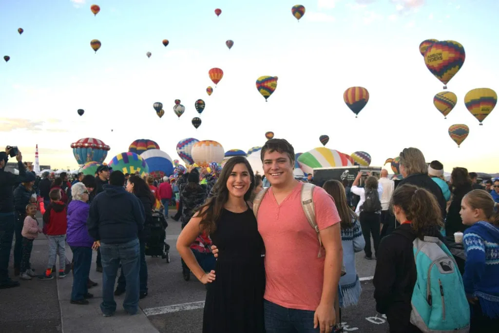 kate storm and jeremy storm smiling at the camera at the albuquerque international balloon fiesta