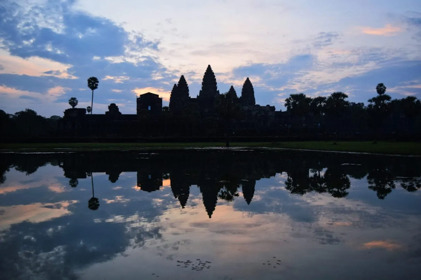 angkor wat sunrise over the main temple, one of the best things to do when touring angkor wat cambodia