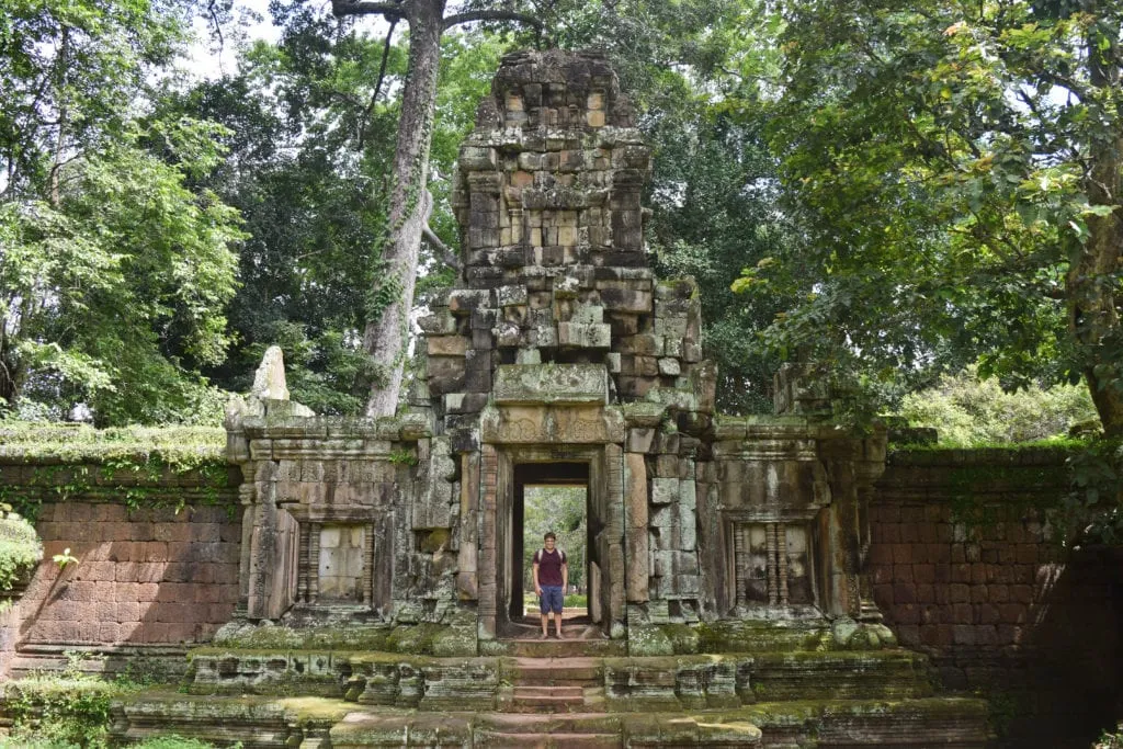 jeremy storm standing in the doorway of a temple when touring angkor wat siem reap