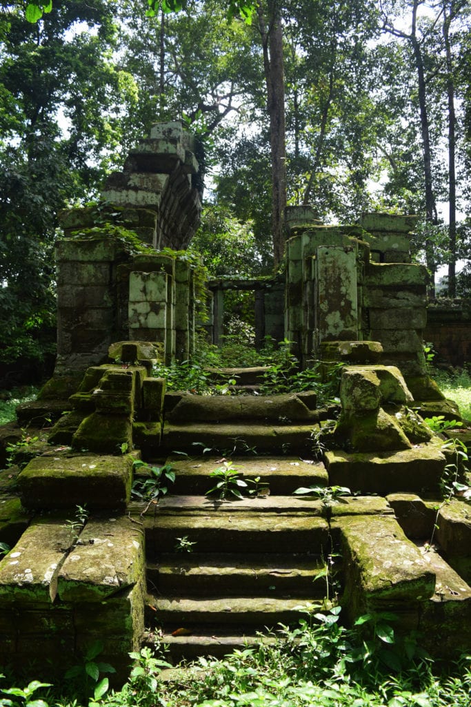 isolated temple seen when visiting angkor wat that is being reclaimed by the jungle