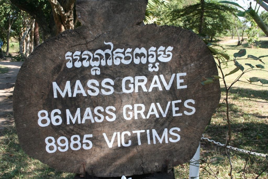 sign marking mass grave at killing fields cambodia