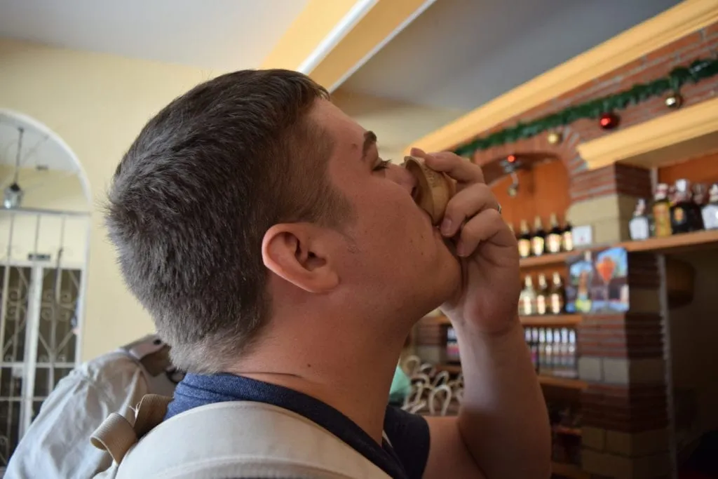 jeremy drinking a glass of mezcal at a tasting in oaxaca mexico