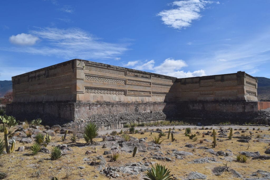 exterior of an intricately carved building in mitla