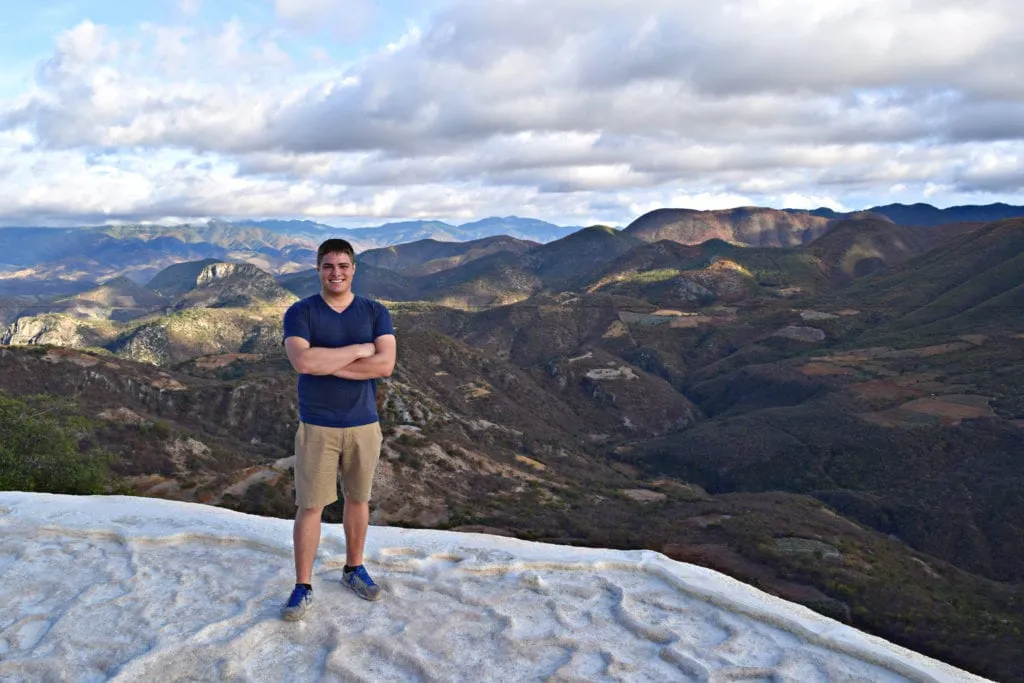 jeremy storm standing on the edge of hierve el agua as an american backpacking mexico