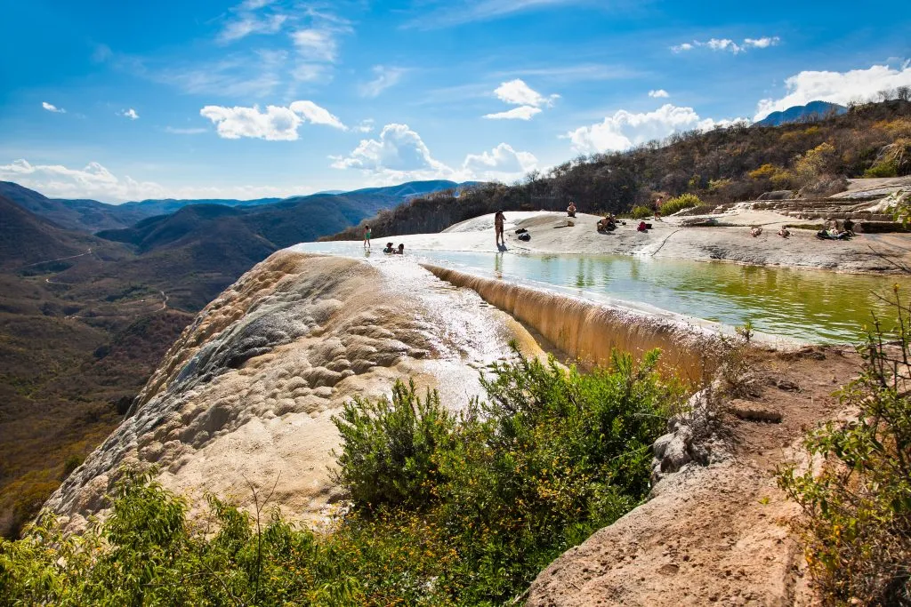 pool of hierve el agua on a sunny day, one of the best places to visit in oaxaca