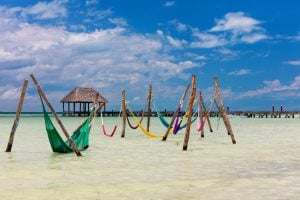 group of colorful hammocks in the water--relaxing here is among the best things to do on isla holbox mexico