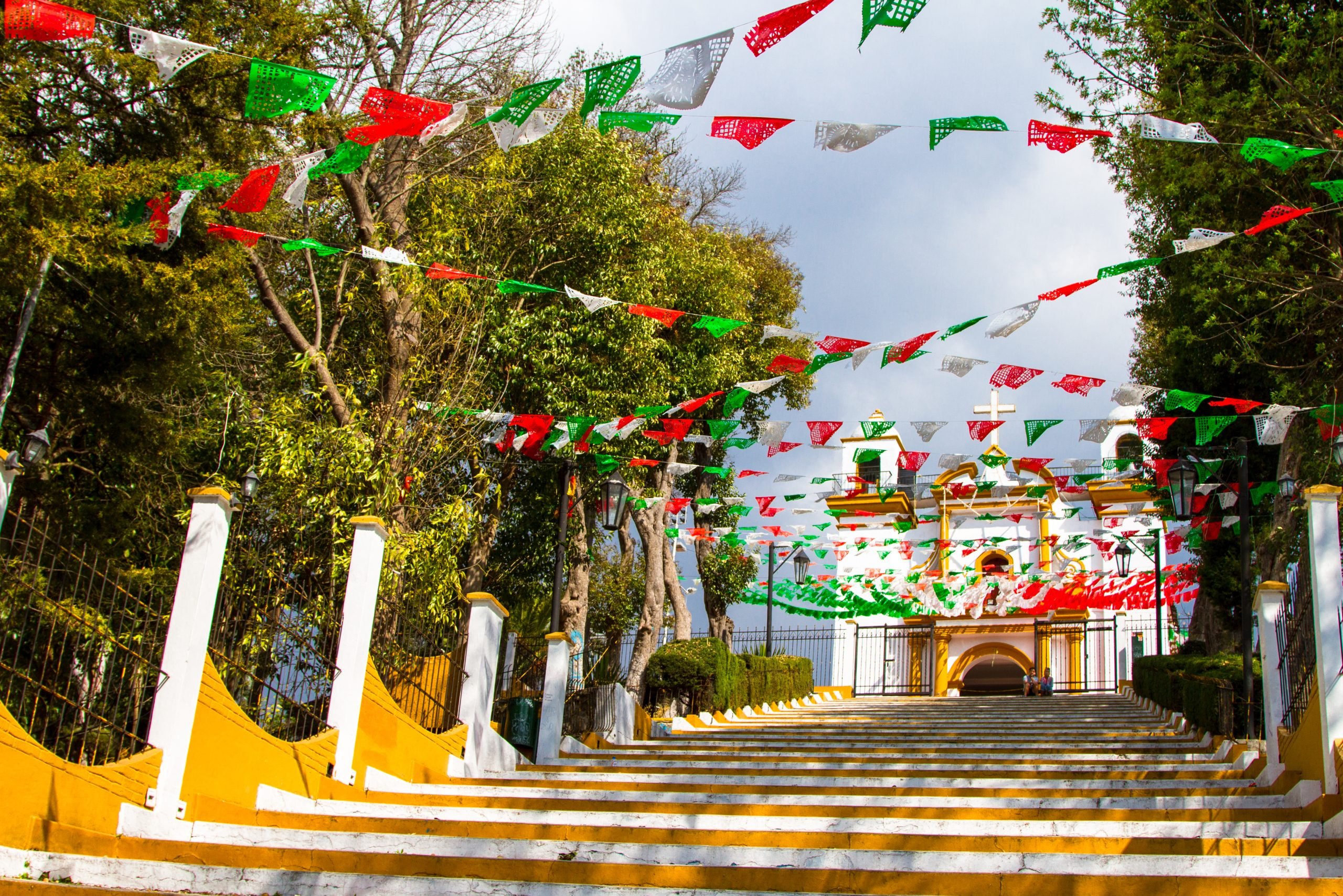 colorful flags leading to a church with viewpoint, one of the best things to do in chiapas mexico