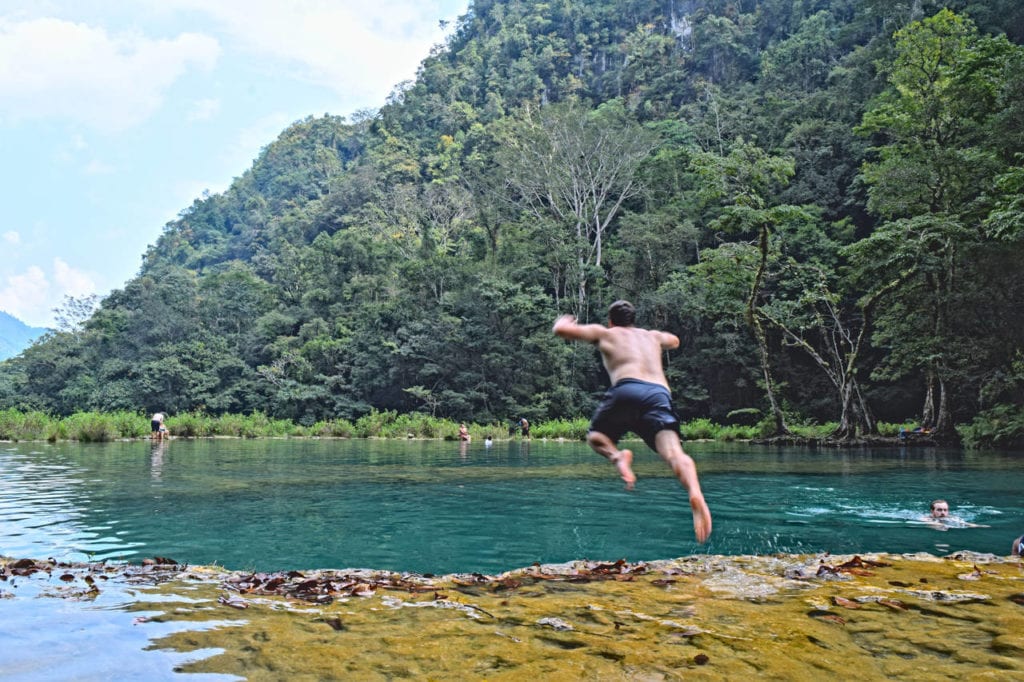 jeremy storm jumping into a pool at semuc champey