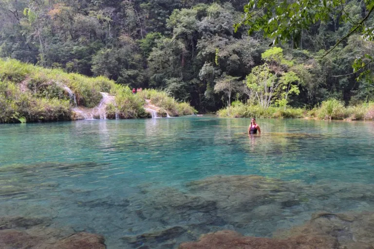 kate storm sitting in a pool with small waterfalls visiting semuc champey guatemala