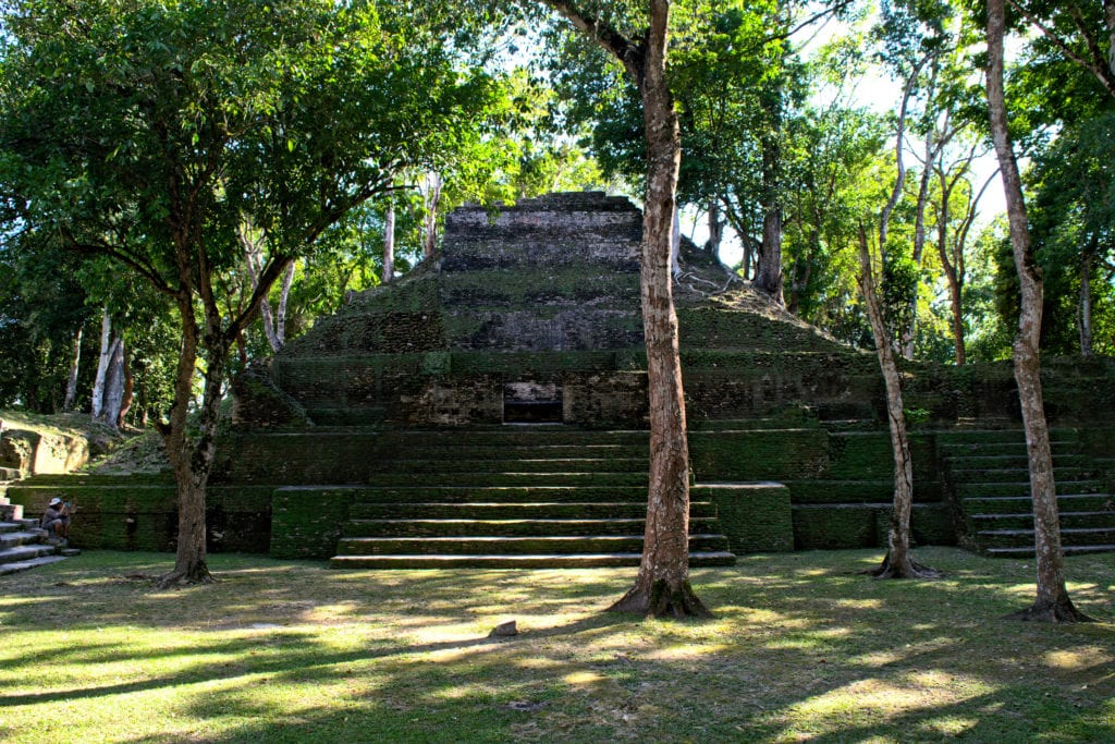cahal pech ruins shaded by trees in san ignacio belize, affordable to add to a trip to belize costs