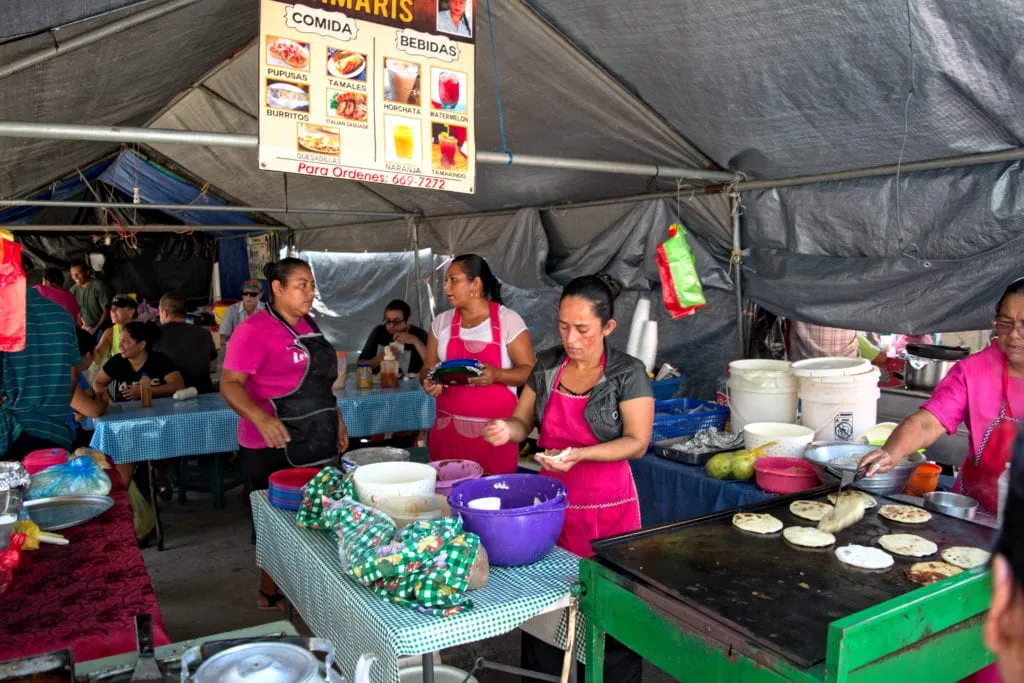 street food market with several women cooking meals in san ignacio belize