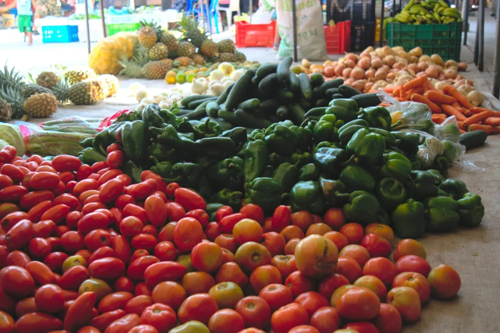 piles of produce for sale at a market in san ignacio belize on a budget