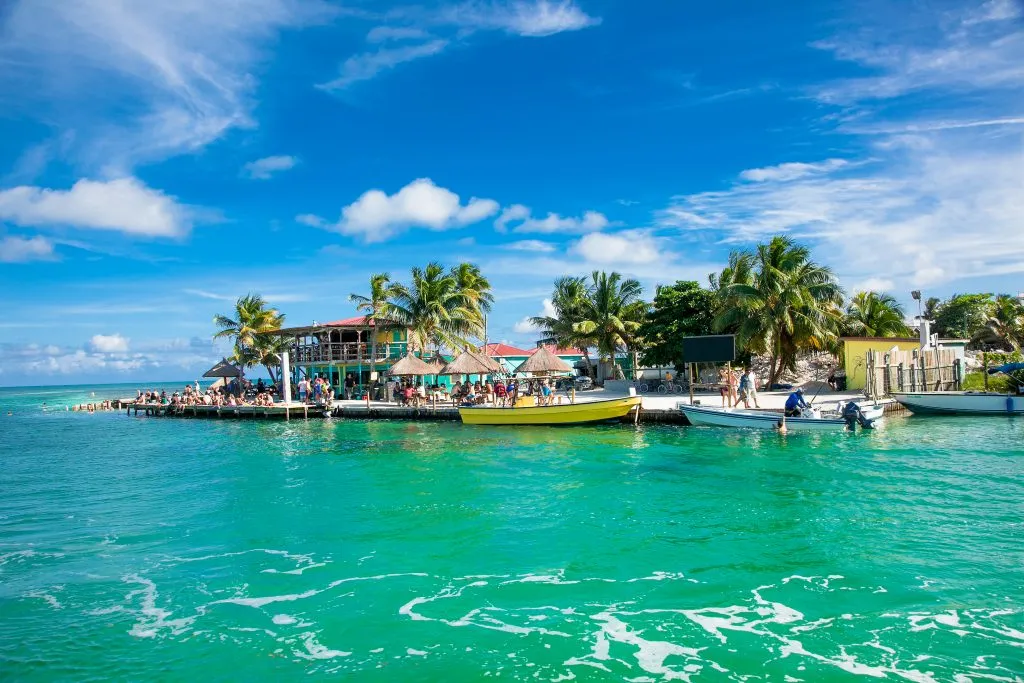 view of caye caulker belize from across the water, one of the best places to visit in belize bucket list