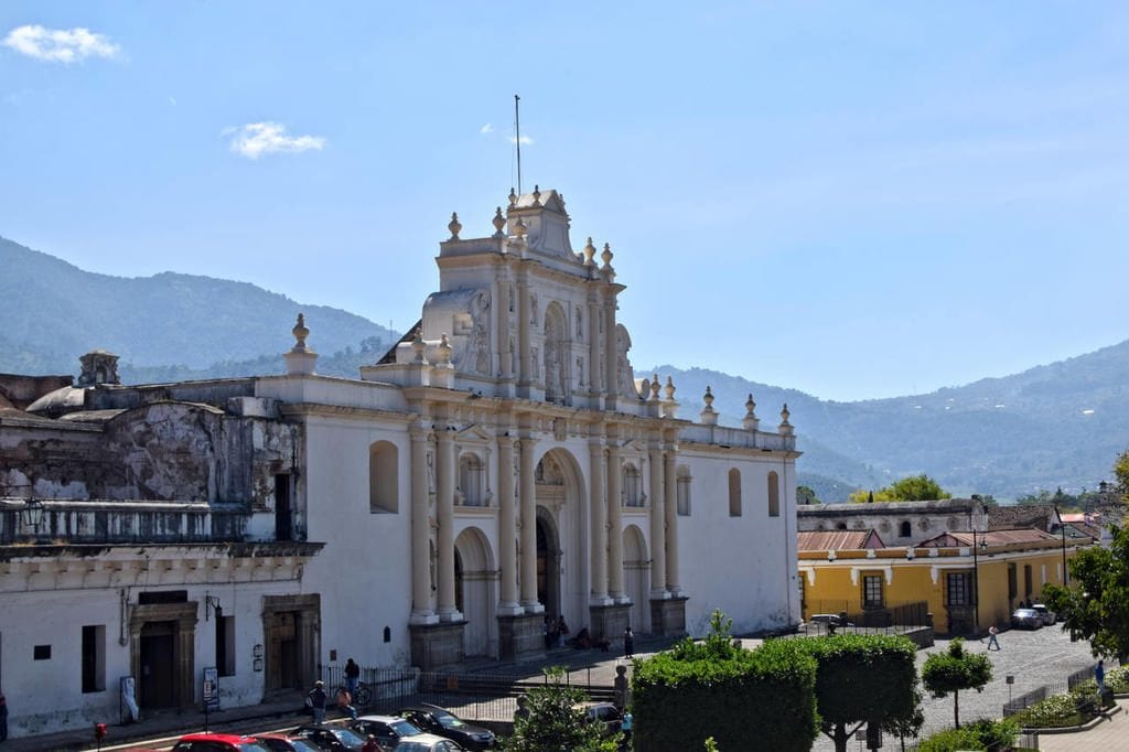 white church in antigua guatemala as seen from above, views like this are worth trip to guatemala cost