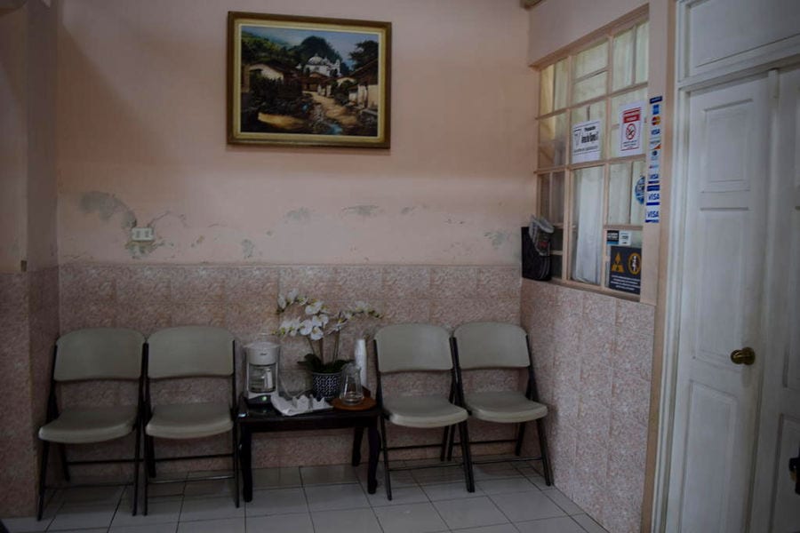 waiting room of a dentist in guatemala with 4 plastic chairs