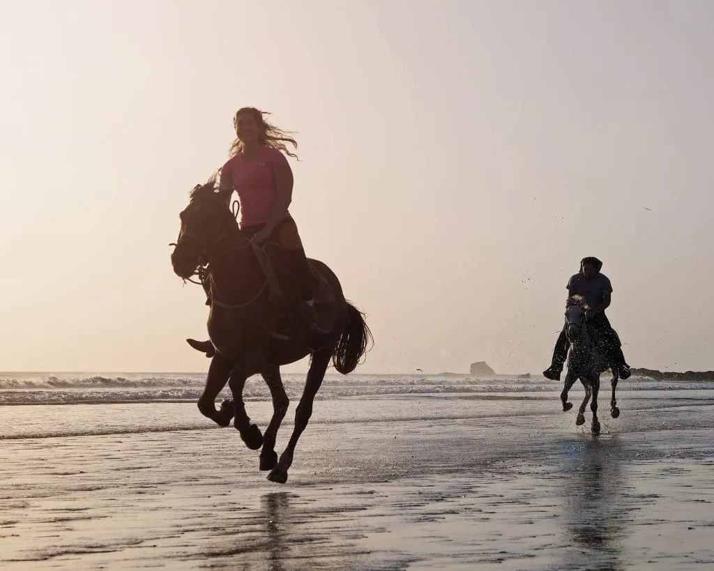 kate storm galloping on a beach while horseback riding nicaragua