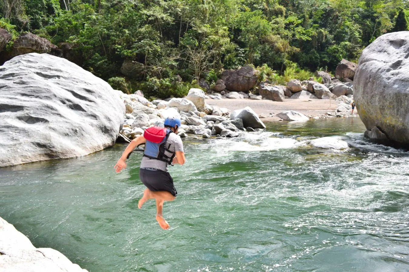 jeremy storm jumping into rio cangrejal during a trip whitewater rafting in honduras