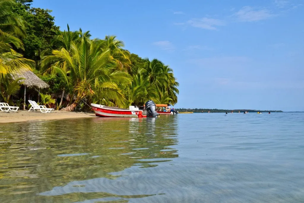 beach in bocas del toro panama with a small boat parked by the shore