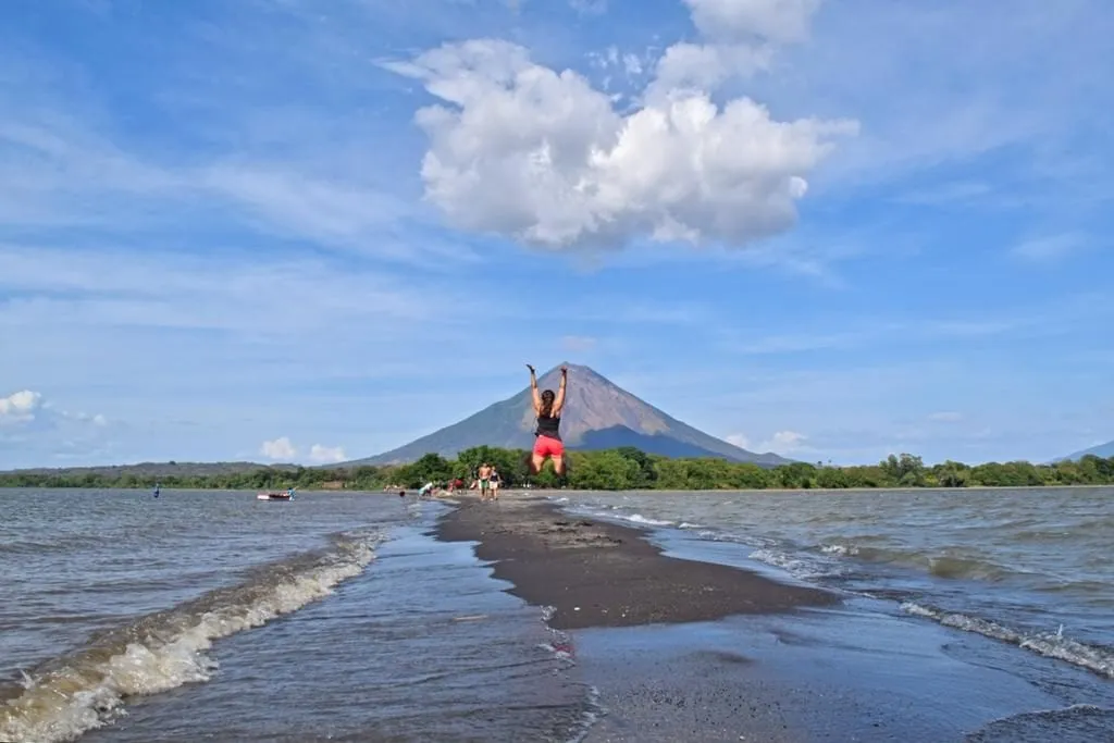 kate storm jumping in the air at la punta on ometepe, a fun stop on a nicaragua itinerary