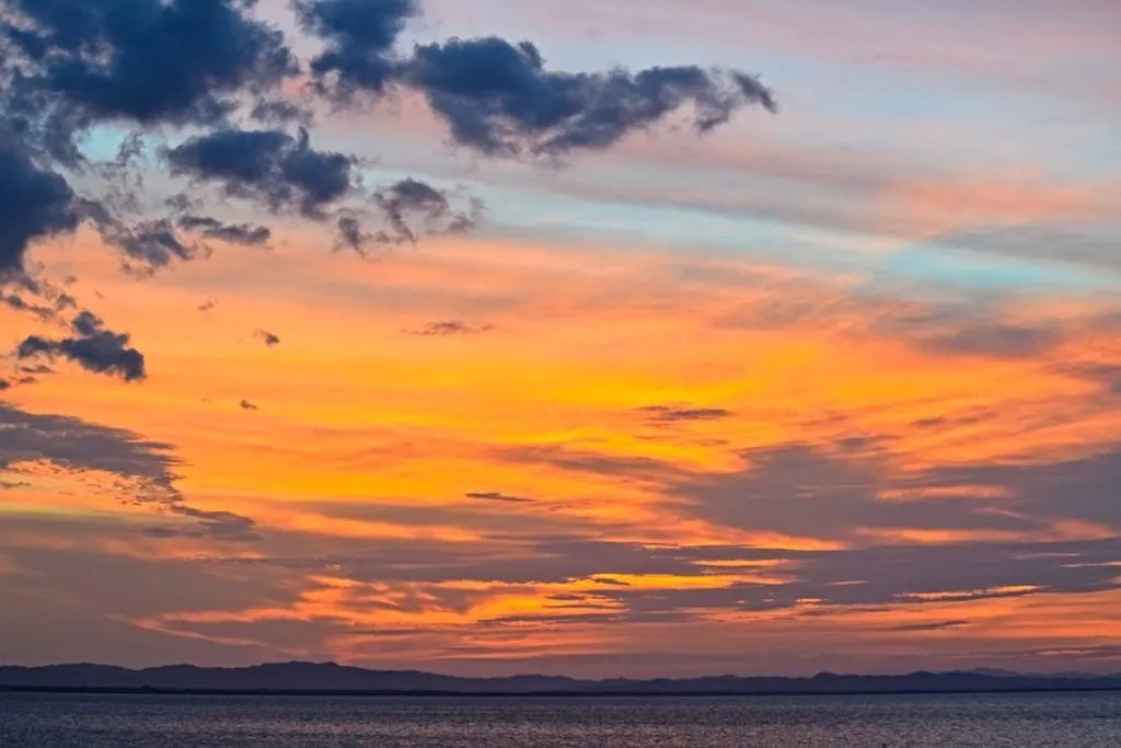 sunset as seen from the shores of ometepe island when backpacking nicaragua