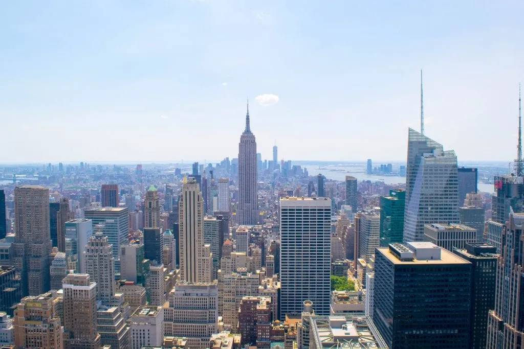 view of manhattan skyline from top of the rock with empire state building in the center