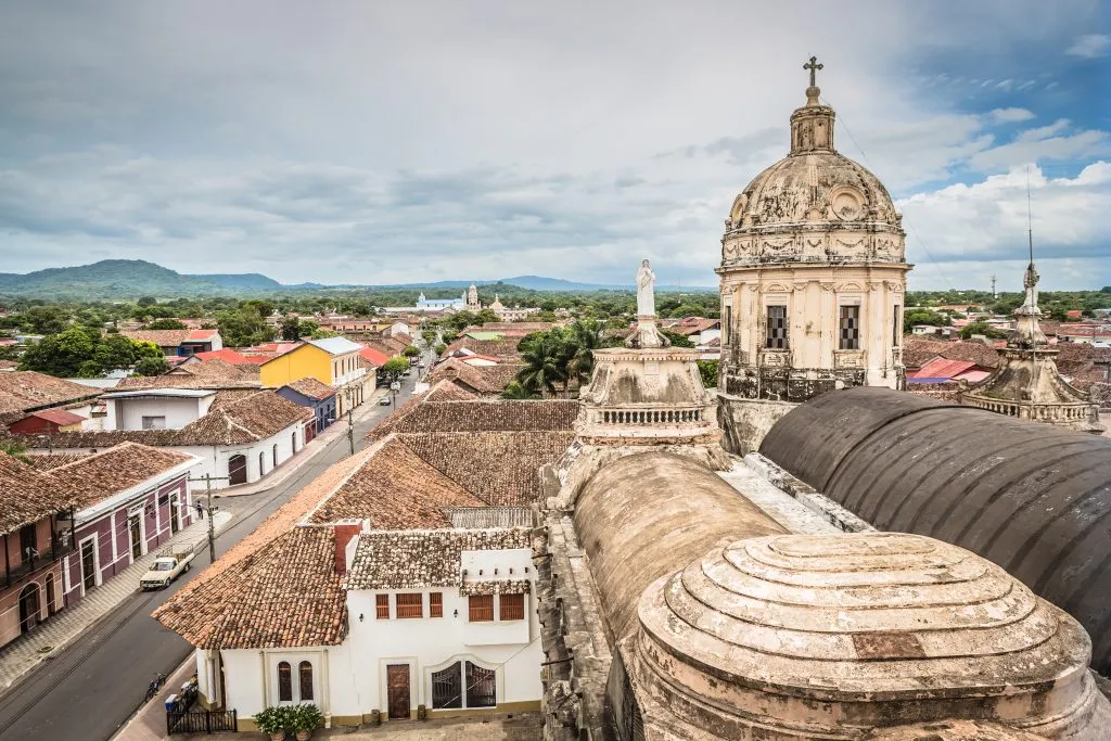 view of the rooftops of granada nicaragua with a church in the foreground