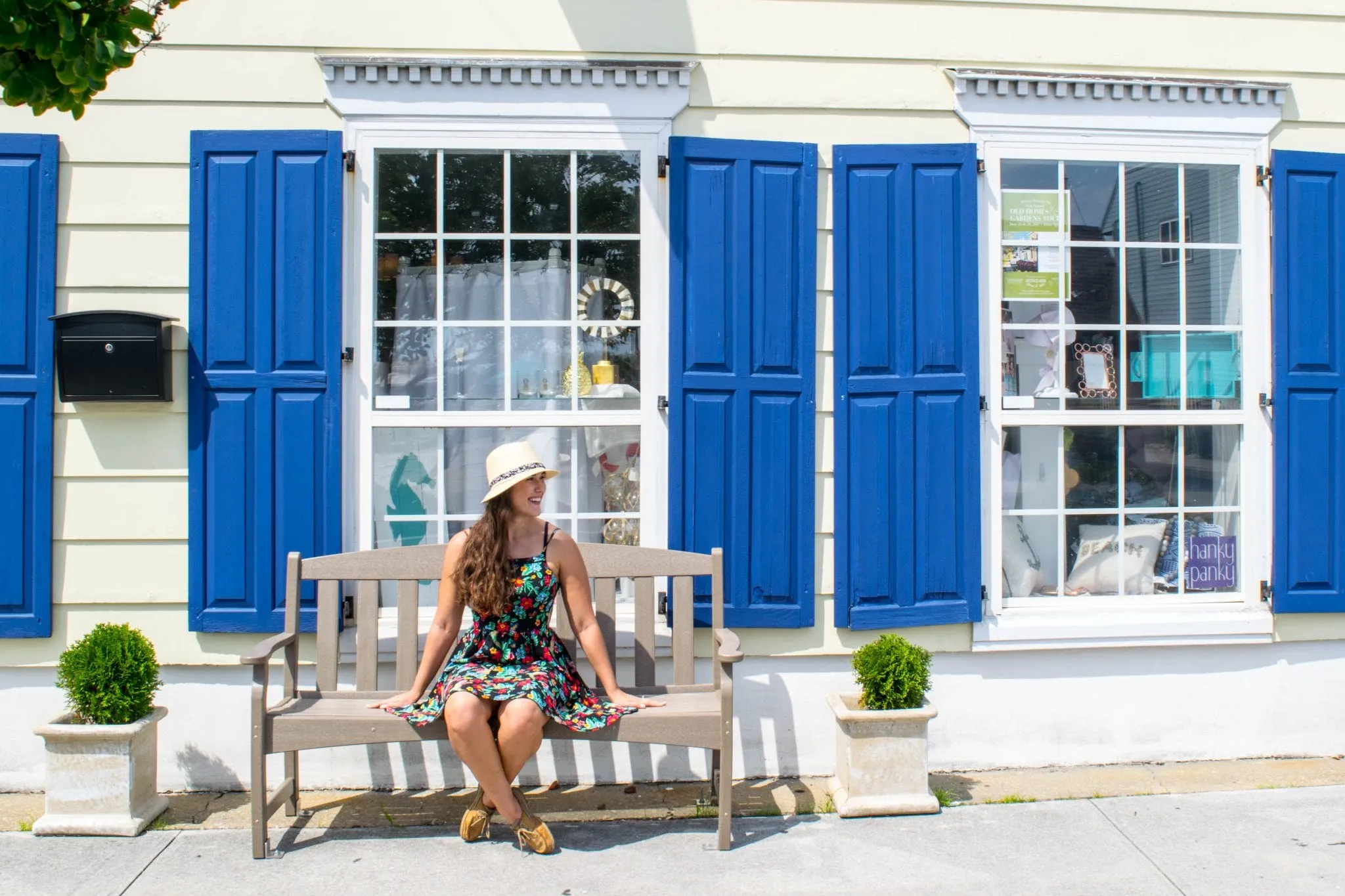 kate storm sitting in front of beaufort linen while exploring the best things to do in beaufort nc