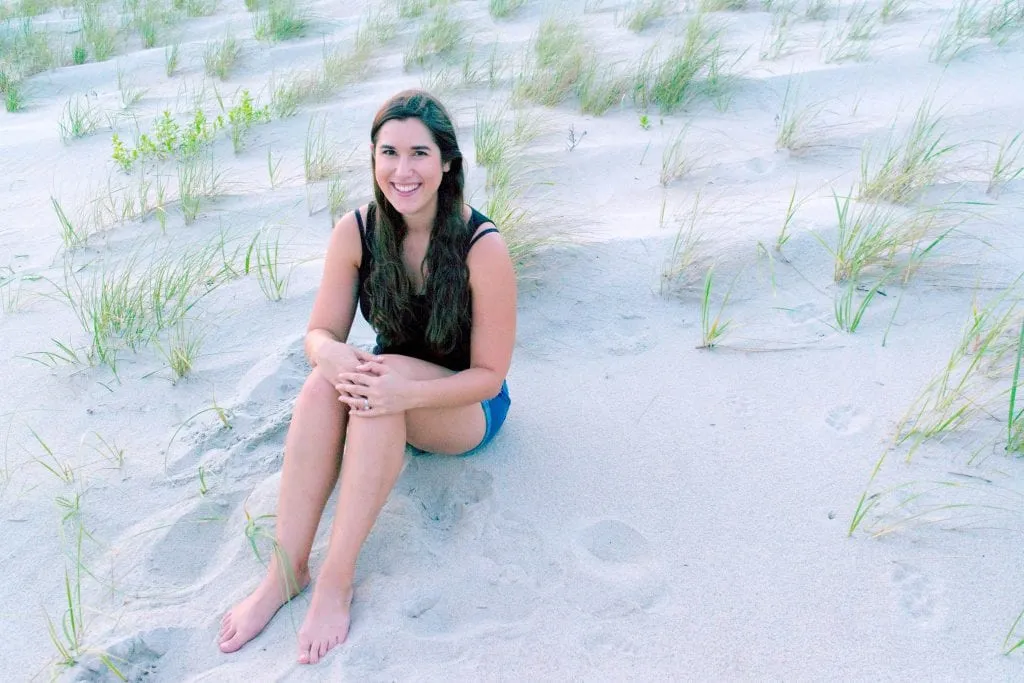 Kate Storm sitting on the beach at Fort Macon State Park NC