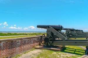 Cannons overlooking Fort Macon NC with the beach visible in the distance
