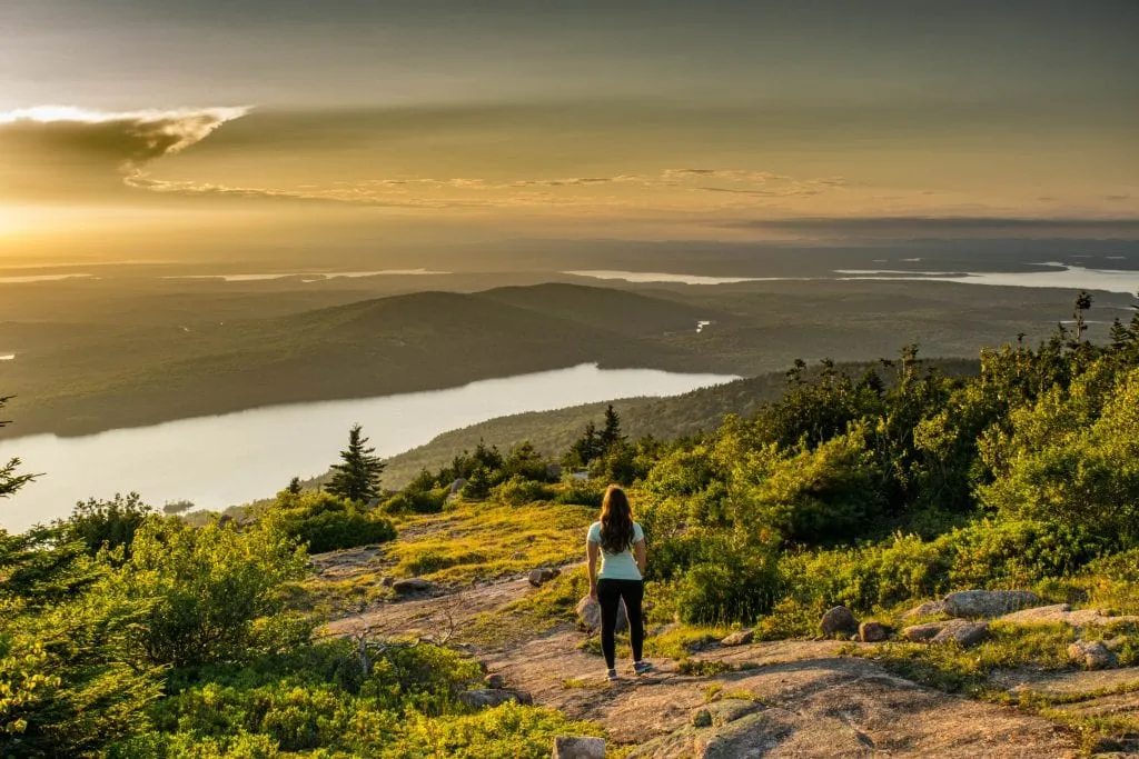 kate storm overlooking the view from cadillac mountain during sunset, one of the best things to do in acadia national park maine