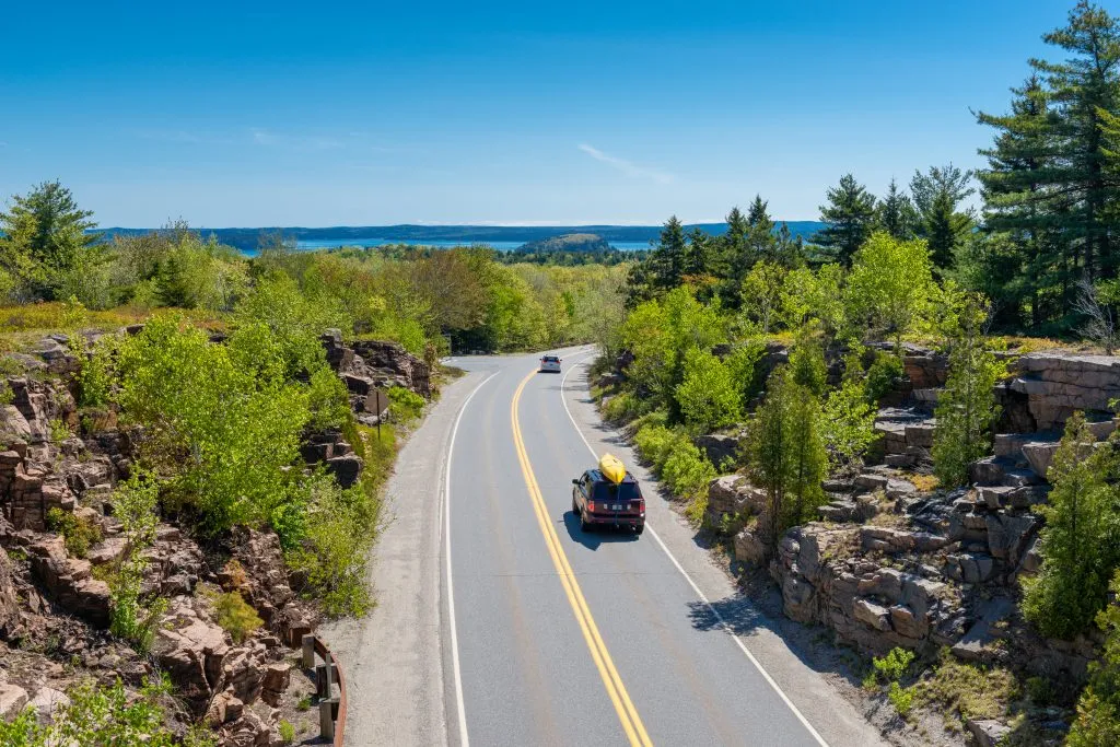 aerial view of cars driving through acadia national park in maine