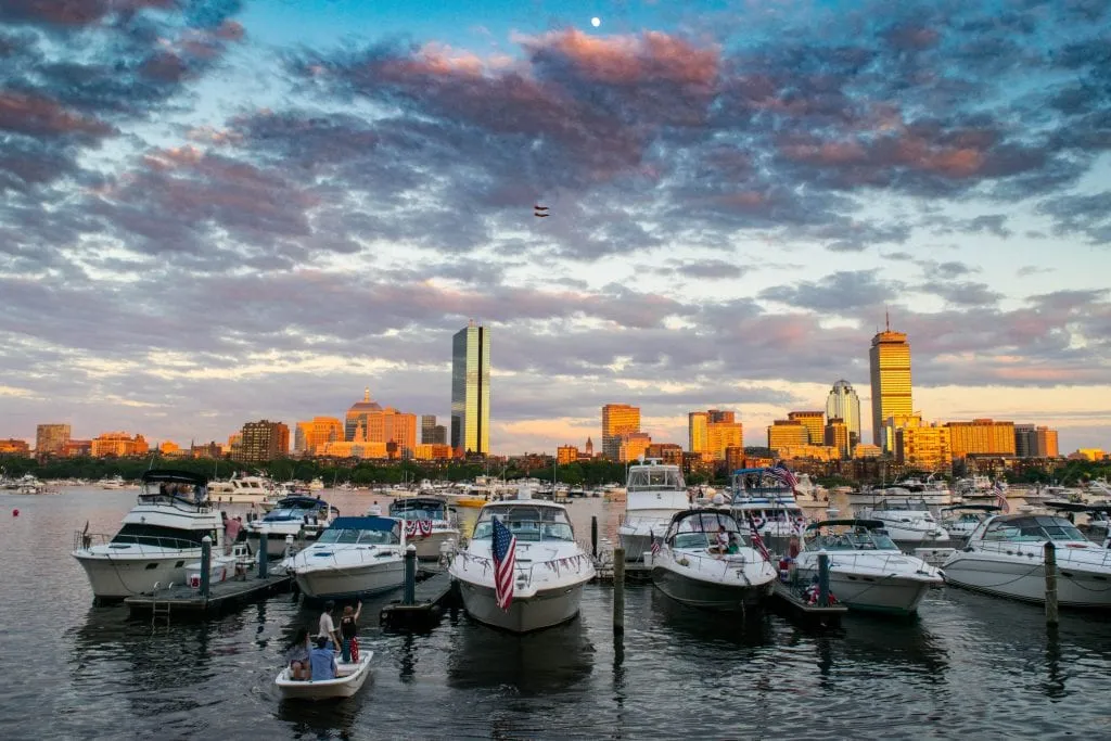 boats in the boston harbor at sunset, a fun addition to an itinerary for boston ma