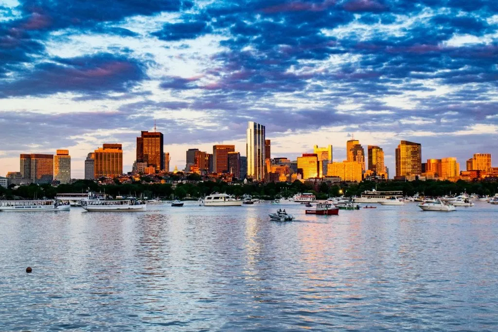 boston skyline at sunset with boston harbor in the foreground
