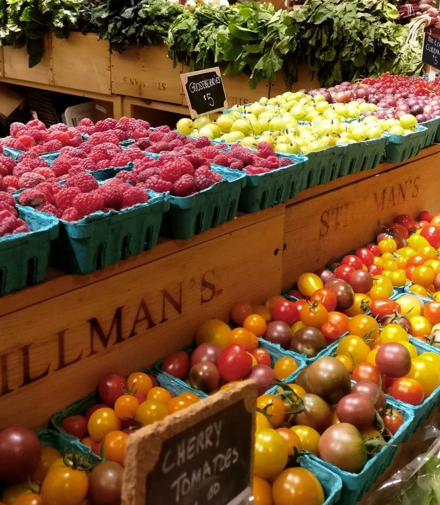 Disply of berries and tomatoes at Boston Public Market, one of the best things to do in Boston MA