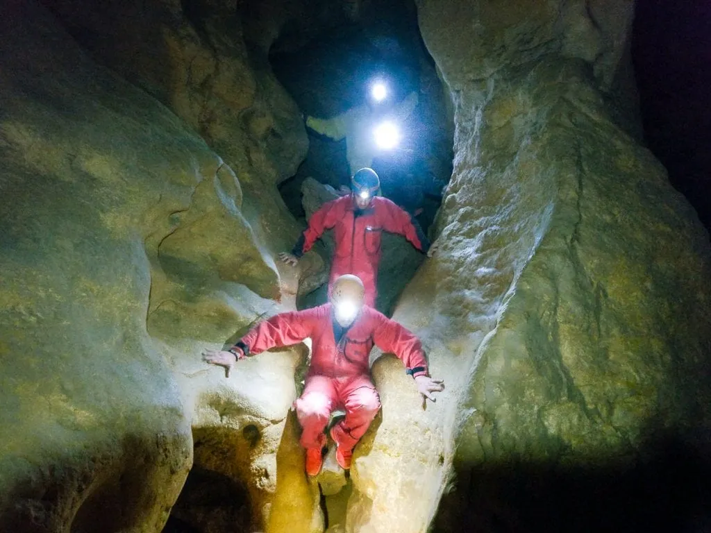 people climbing into a cave in budapest hungary