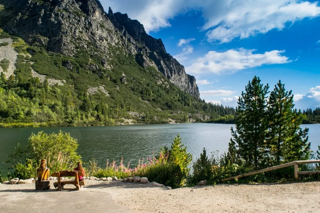 kate storm sitting in front of Popradske Pleso slovakia