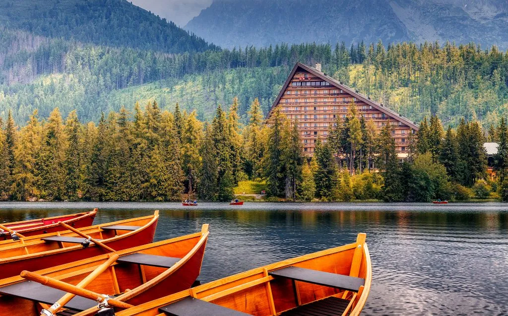 strbske pleso with rowboats in the foreground and hotel in the background