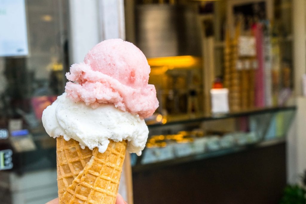 2 scoops of gelato, pink on top and white on bottom, balanced on a cone. Gelato definitely belongs on any list of what to do in Florence at night